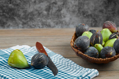 Close-up of fruits in basket on table