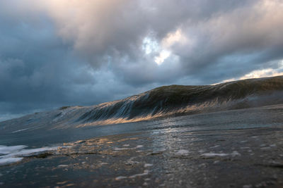 Scenic view of sea against storm clouds