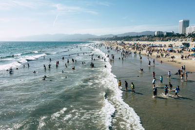 High angle view of people on beach against sky