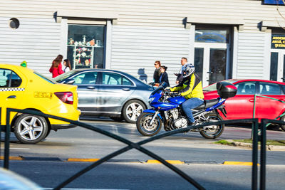 Side view of people cycling on street