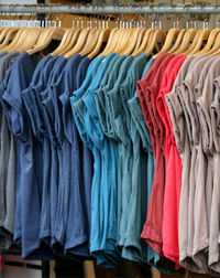 T-shirts hanging on rack in store