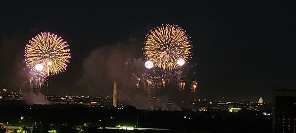 Low angle view of firework display at night