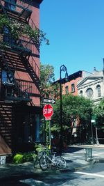 Bicycle in city against clear sky