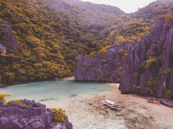 High angle view of river amidst trees against mountains