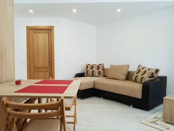 Empty chairs and table against wall at home