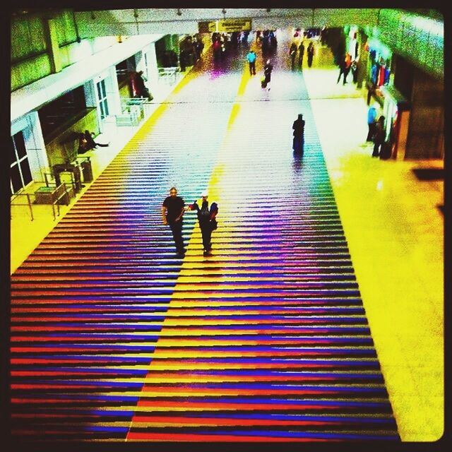 lifestyles, men, walking, person, leisure activity, transfer print, steps, high angle view, large group of people, auto post production filter, togetherness, city life, full length, built structure, steps and staircases, medium group of people, staircase, shadow