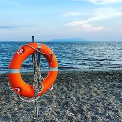 Rope hanging on sea against sky