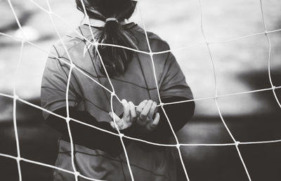 Rear view of child in soccer goal