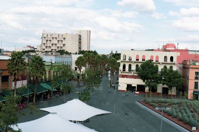 Exterior of buildings in town against sky