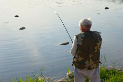 Rear view of man standing in lake