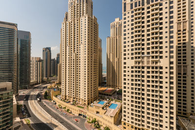 Aerial view of buildings in city against clear sky