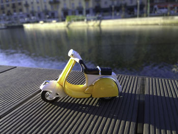 Yellow vespa model parcked by navigli in italy