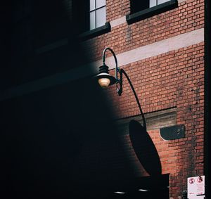 Low angle view of street light against building