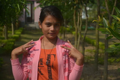 Portrait of woman standing outdoors