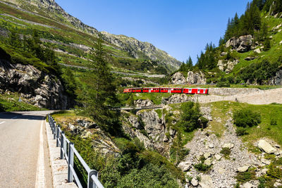 Typical swiss touristic red train climbing up the furka railway, switzerland