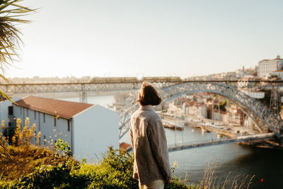 Rear view of woman standing against building