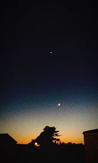 Low angle view of silhouette trees against sky