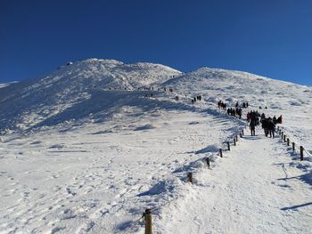 Scenic view of snowcapped mountain against clear sky