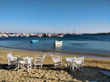 Boats on beach against clear sky