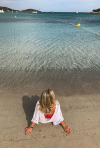 Rear view of boy on beach