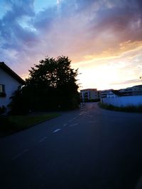 Road against cloudy sky at sunset