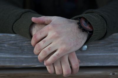 Close-up of woman hand on table