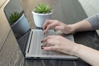 High angle view of man using laptop on table