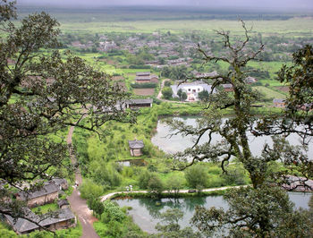 Scenic view of lake by trees and buildings