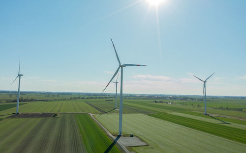 Windmill on field against sky