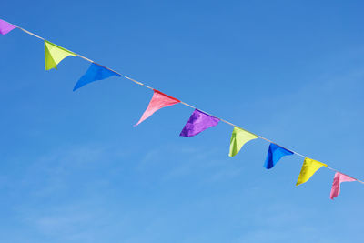 Low angle view of flags against sky