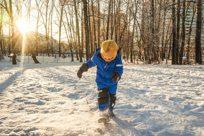 Full length of boy on snow covered land