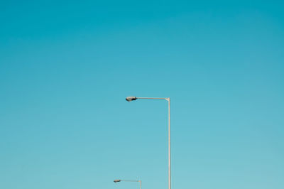 Low angle view of street light against clear blue sky