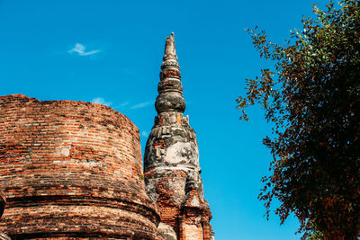 Low angle view of old temple against blue sky