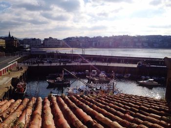 View of harbor against cloudy sky