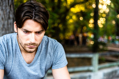 Close-up of young man sitting outdoors