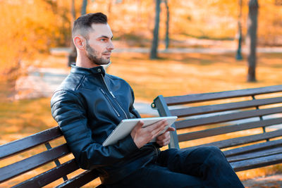 Man sitting on bench in park