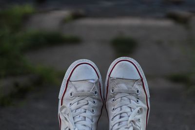 Low section of person wearing shoes standing outdoors