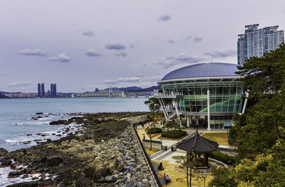 Modern buildings against cloudy sky