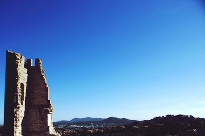 Low angle view of historic building against clear blue sky