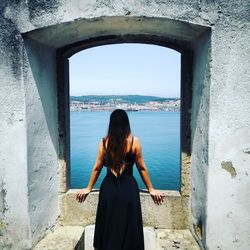 Rear view of woman looking at sea