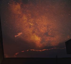 Low angle view of silhouette mountain against sky at night