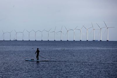 People on sea against sky