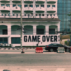 Information sign on street against buildings in city