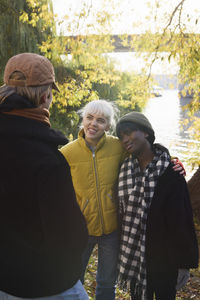 Smiling young friends talking outdoors