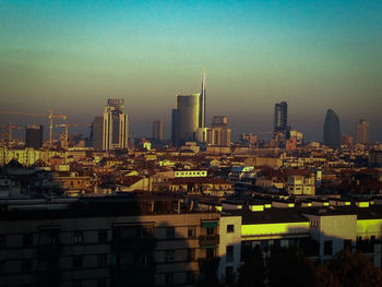 Modern buildings in city against clear sky
