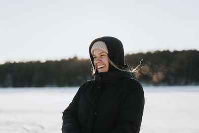 Woman standing on frozen lake