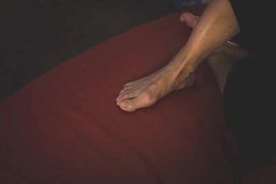 Low section of man relaxing on floor