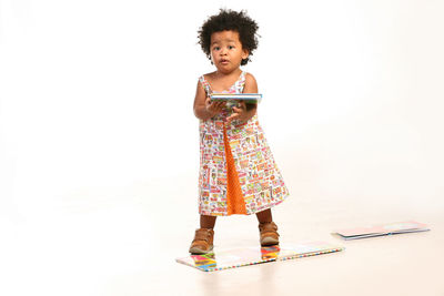 Toddler girl holding a book