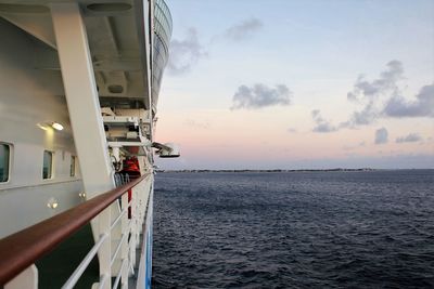 Ship sailing on sea against sky during sunset