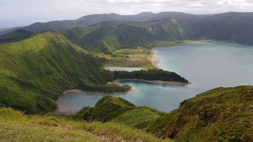 Scenic view of lake and mountains against sky